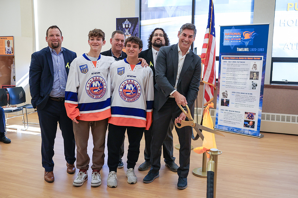 Ribbon cutting for new hockey display section. Left to right: Back Row: Matthew Goldberg, Rick Lewis, Jason Bartow Front Row: Alex Klonsky, Corey Jacobs, Mathieu Schneider